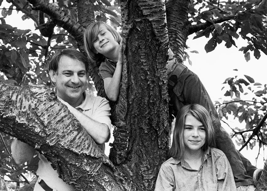 black and white photograph of Eric Carle and his son and daughter in a tree