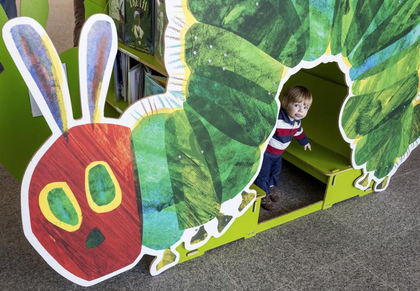 Child with The Very Hungry Caterpillar bookcase