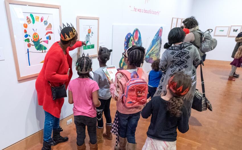 Children looking at art in the galleries with an adult