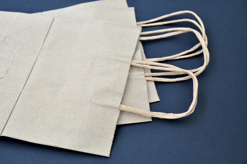 Three brown paper bags fanned out on a black background. 
