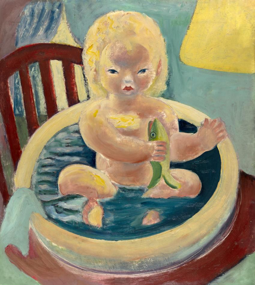 Boy holding fish in bathtub.
