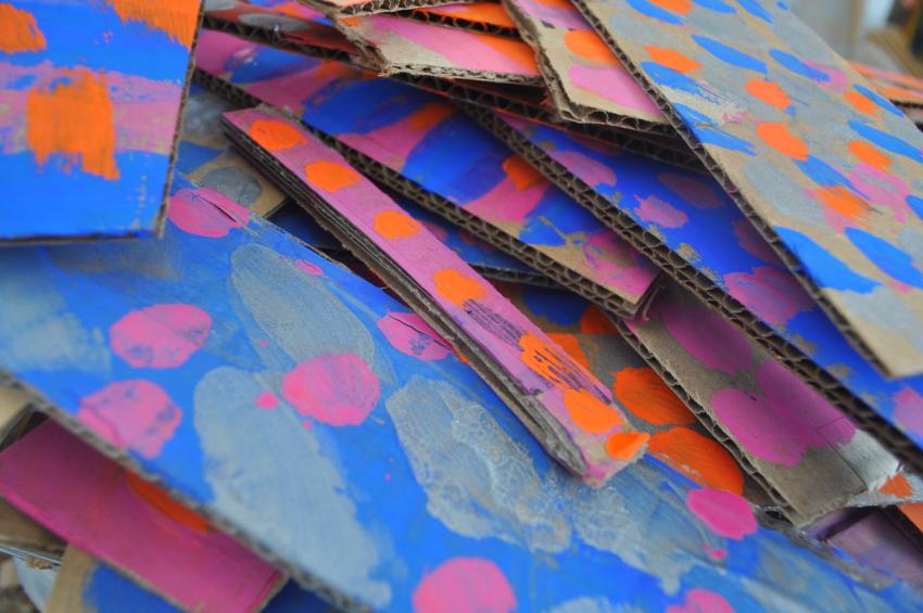 A stack of colorfully-painted cardboard pieces. 