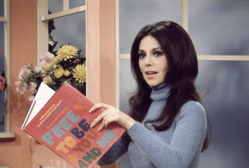 Photograph of woman holding book 