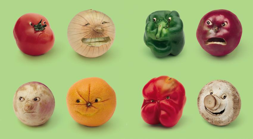 Eight vegetables with faces making different expressions against a green background.
