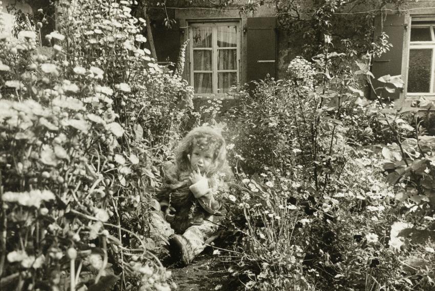 Photograph of child in garden. 