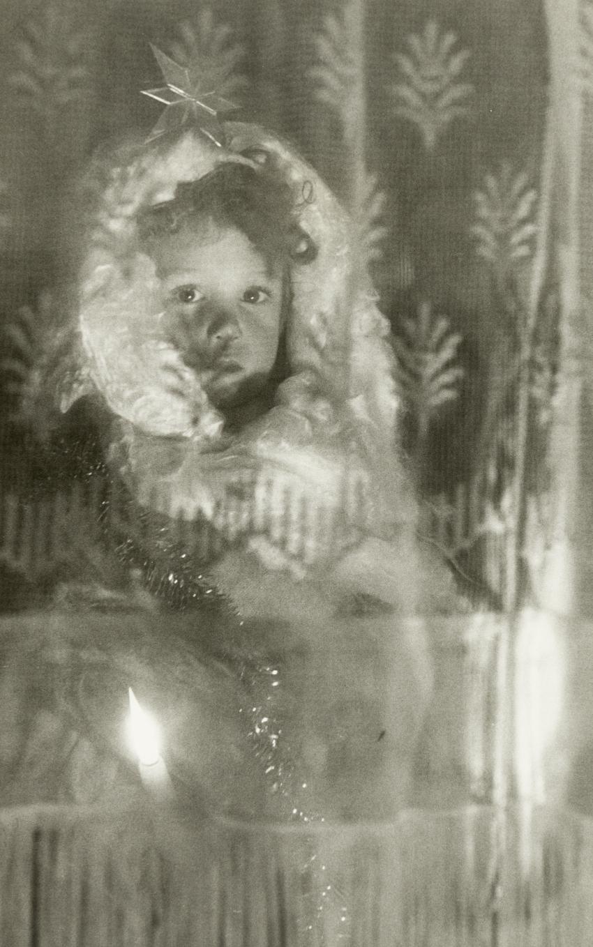 Photograph of child in window. 