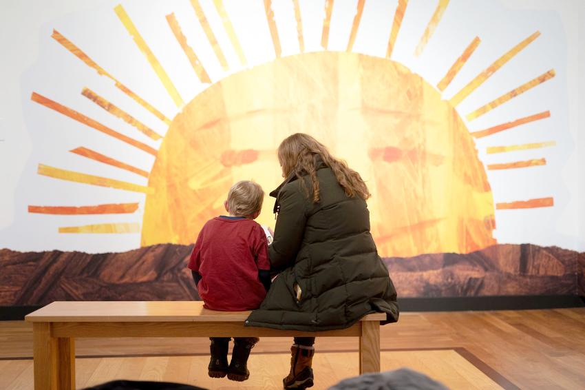Photograph of woman and child reading. 