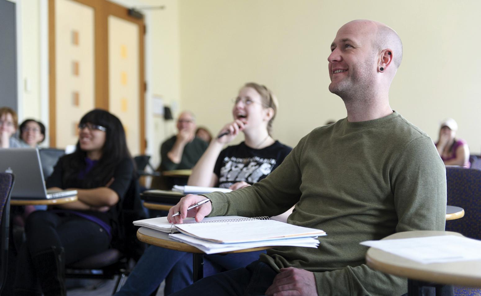 Simmons student laughing in lecture.