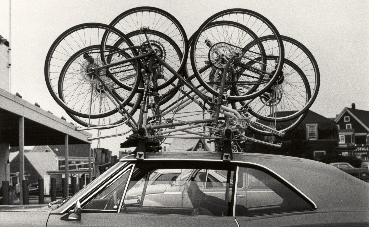 Photograph of bicycles on roof of car.