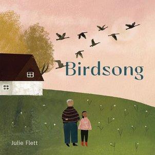 A child and grown-up with white hair look up at geese flying in a V across a pink sky.