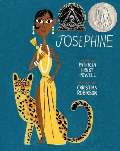 A black woman wearing a yellow evening gown and pearls standings next to a cheetah.