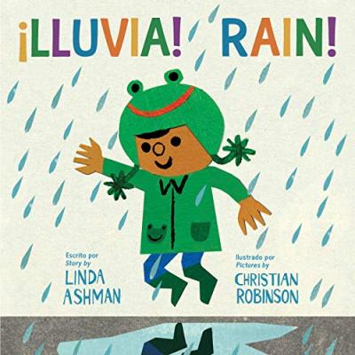 A child in a green raincoat, rainboots and frog hat jumps in a puddle in the rain.