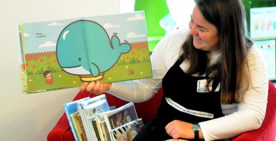 Reading Librarian reading a picture book to a group of children
