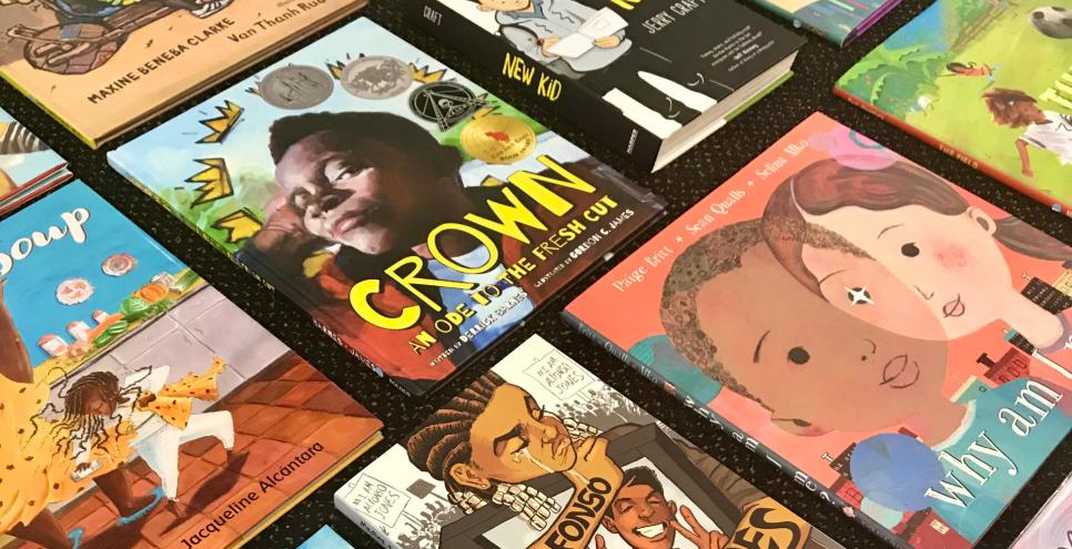 Multiple picture books by Black creators are arranged in a grid on a black background