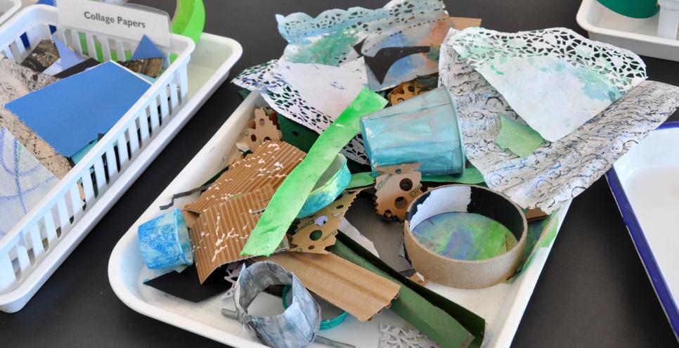 A tray of paper found materials including doilies, cardboards, and colorful papers.