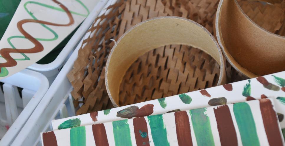 A basket of green and brown paper materials.