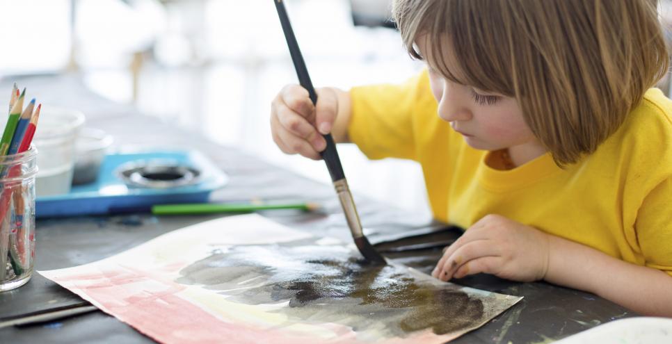 Child painting in Art Studio. 