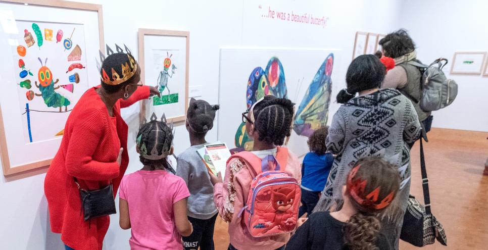 Children looking at art in the galleries with an adult