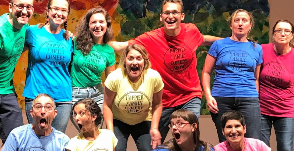 Happier Family players on stage in an assortment of colored T-shirts