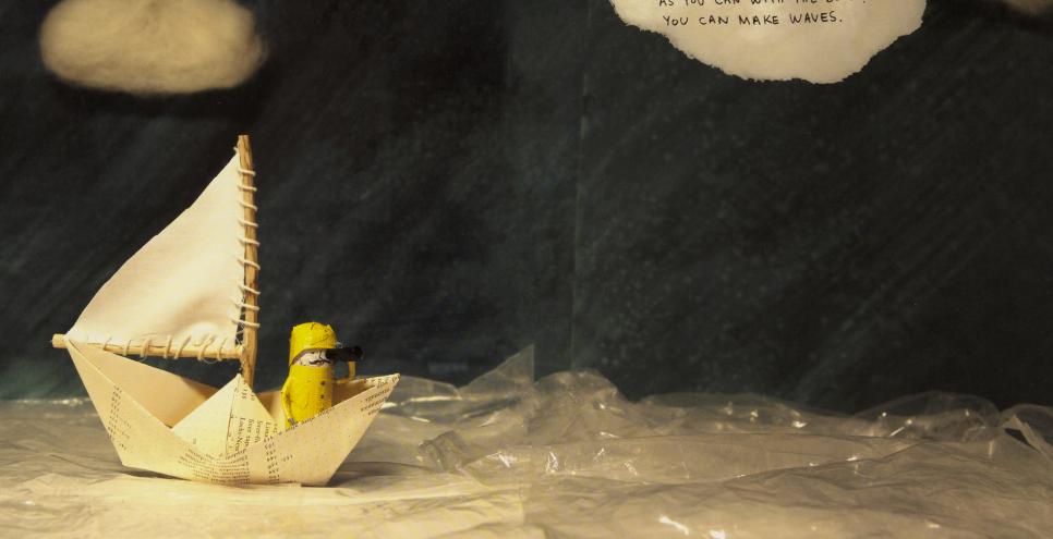 Collage of figurine in paper boat sailing across water made of plastic wrap.