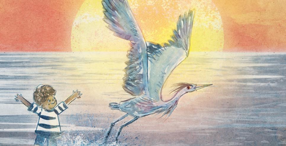 a boy in a striped shirt playing with a heron in the ocean