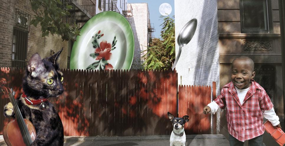 Photographic collage of boy with dog and plates and cat playing fiddle. 