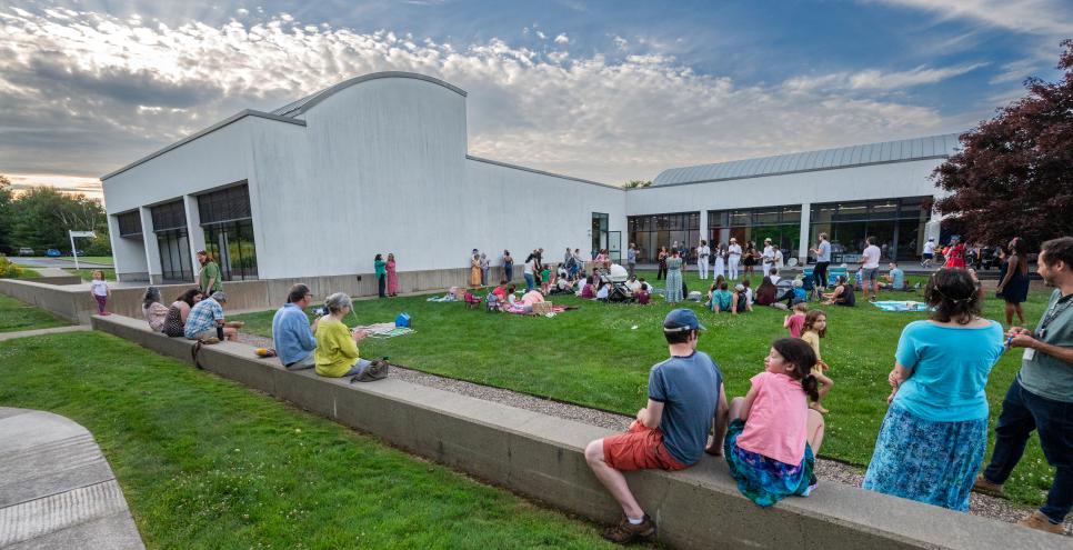 Guests in the courtyard enjoying music during Summer Nights evening.