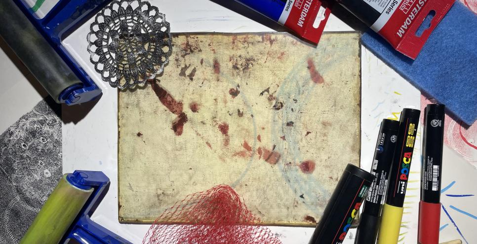 photograph of some printmaking brayers, a gelli plate, acrylic inks and acrylic markers. 