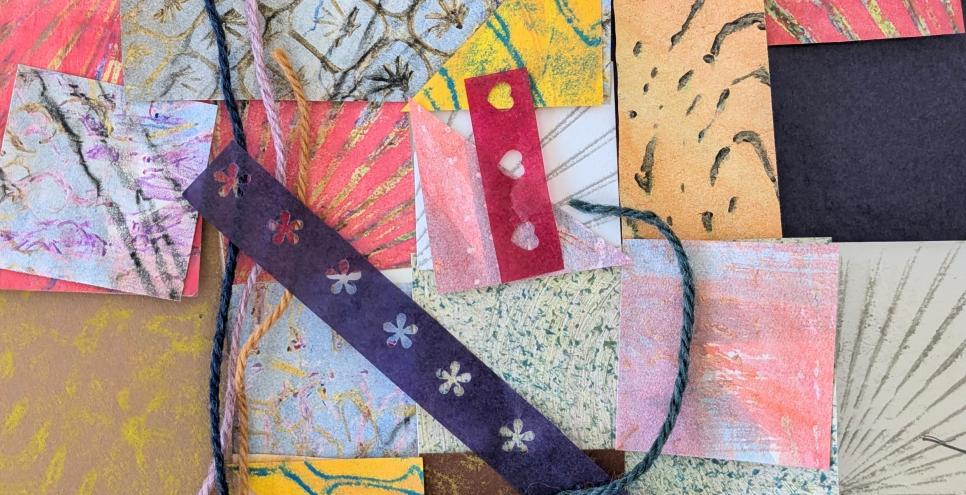 An array of colorful textured papers and yarn overlapping. 