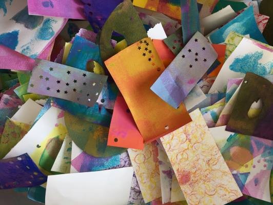 A pile of many colorful collage papers