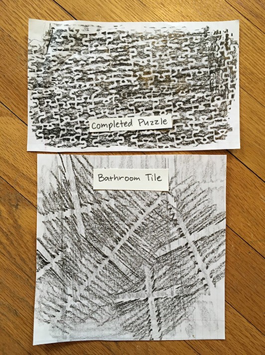 Black and grey texture rubbings of a completed puzzle and bathroom tile.