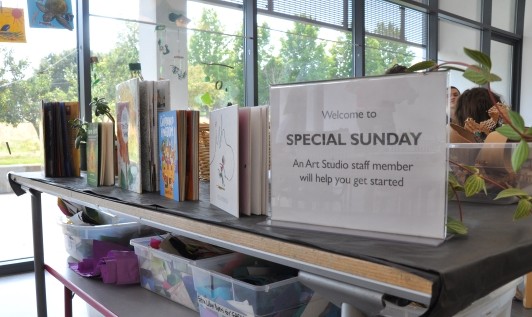 Table with inspiring picture books and a sign that reads Welcome to Special Sunday!